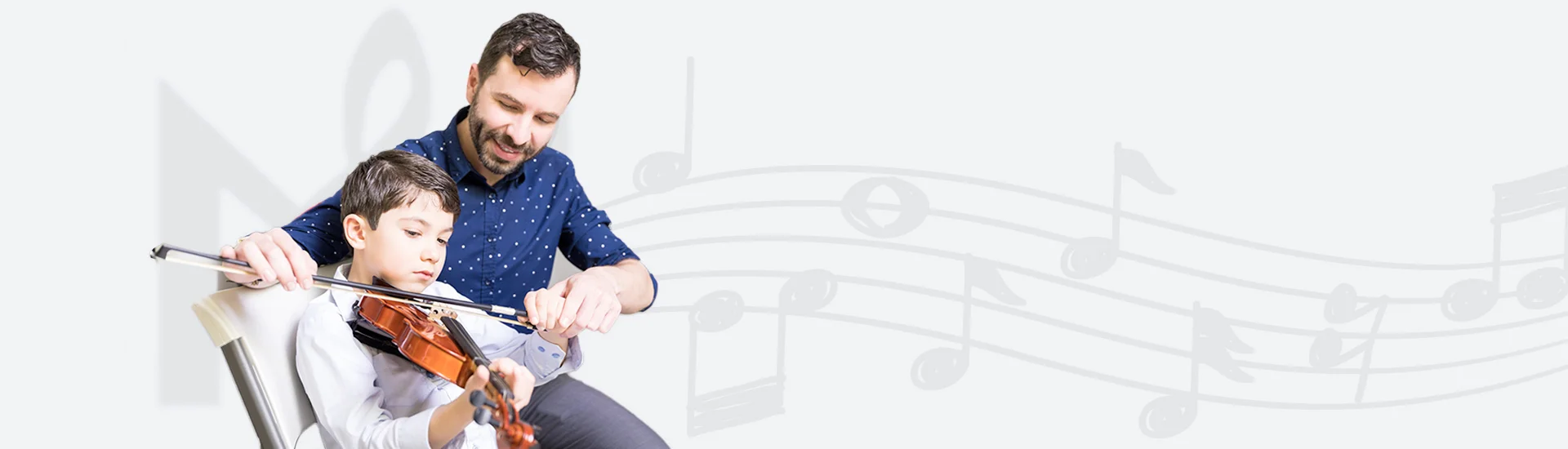 Volin instructor teaching a young boy to play the violin